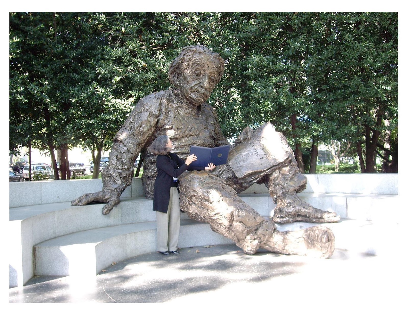 Susan Eggers showing her award to statue of Albert Einstein