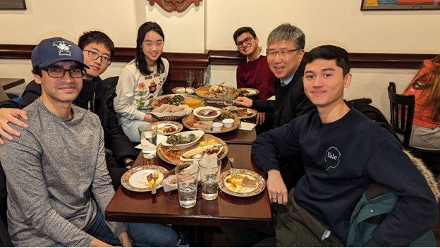 Professor Ha Jun Chang with students at dinner