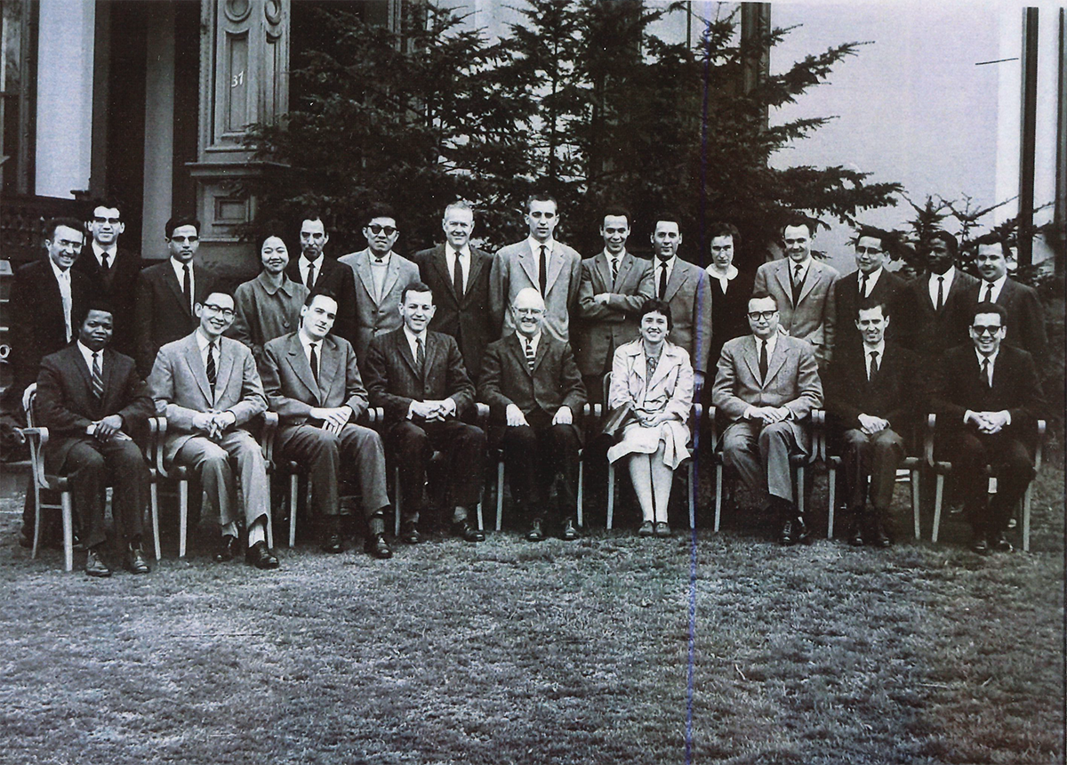 A black and white photo showing a group of students posed for a group portrait on a lawn