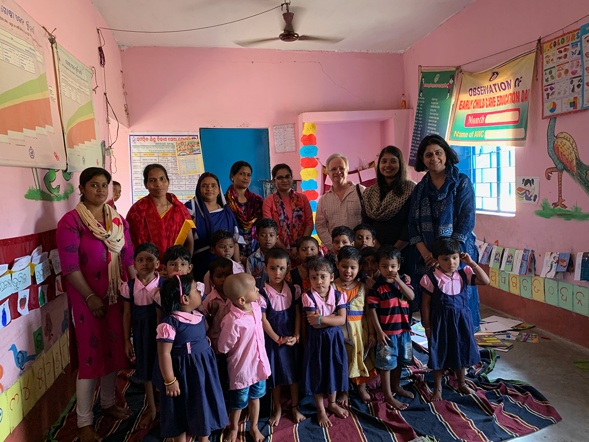 A group poses at a school for young children
