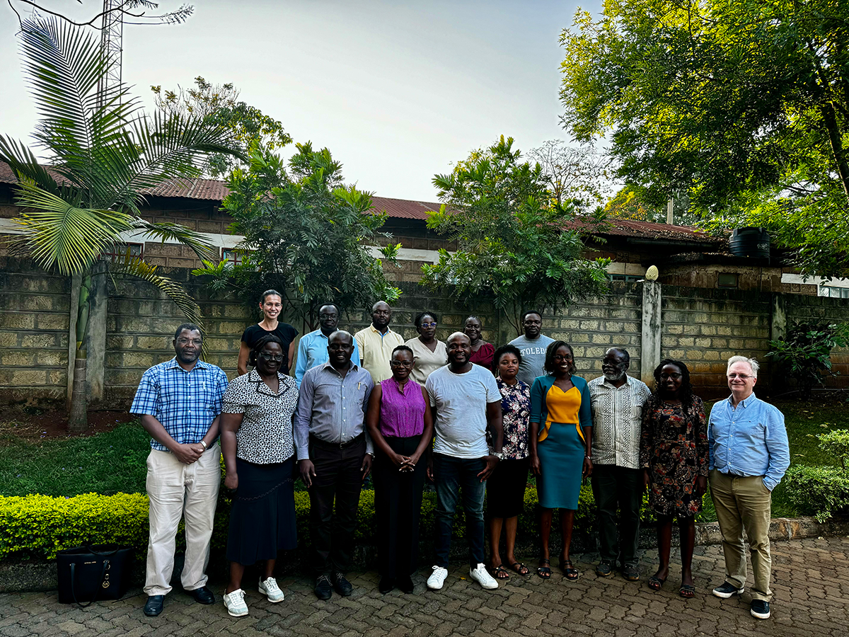 A group poses in a tropical climate