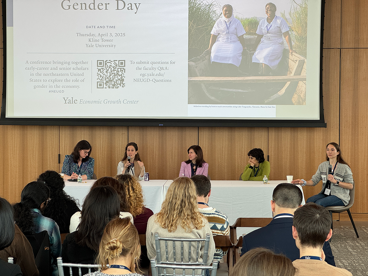 A panel at the front of a conference