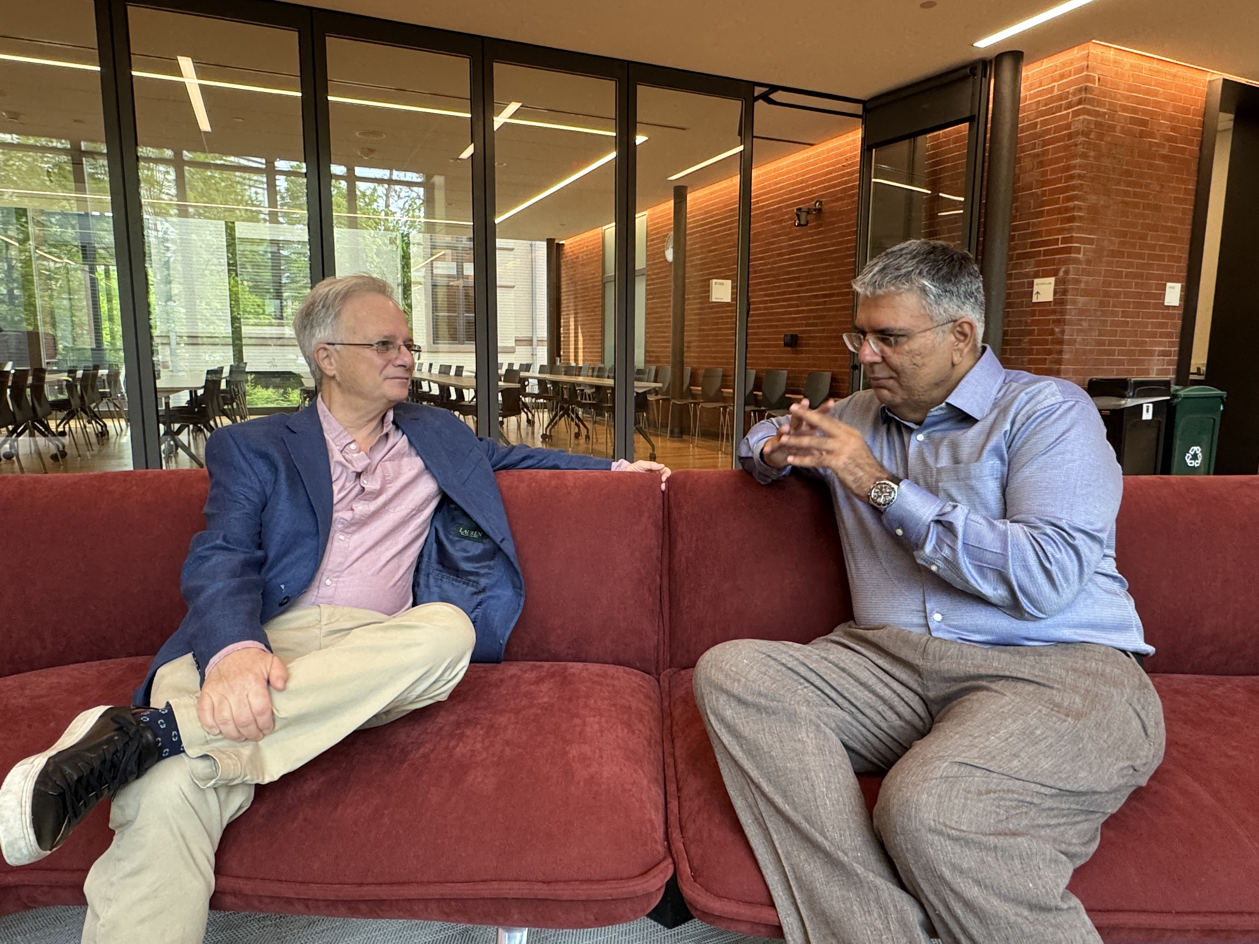 Image showing economists Costas Meghir (Yale) and Amer Hasan (World Bank) engaged in a discussion
