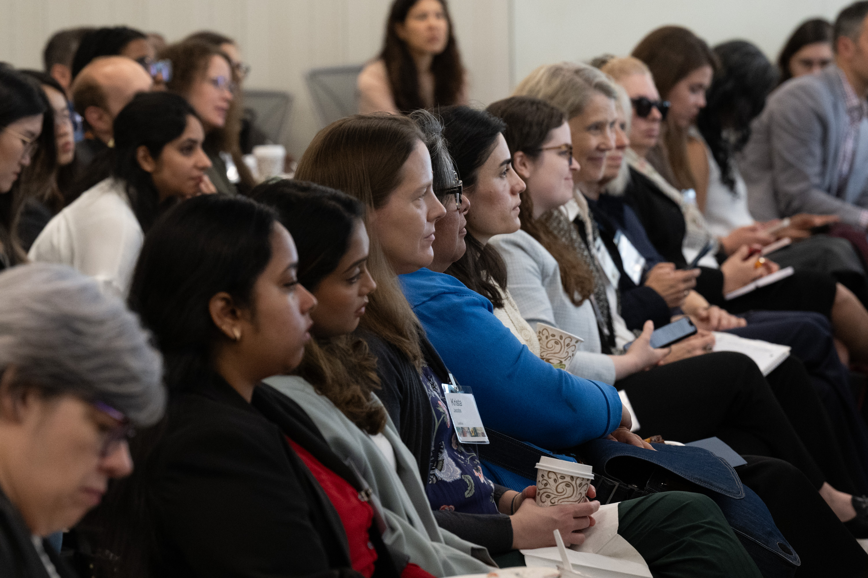 Audience members listen to a discussion