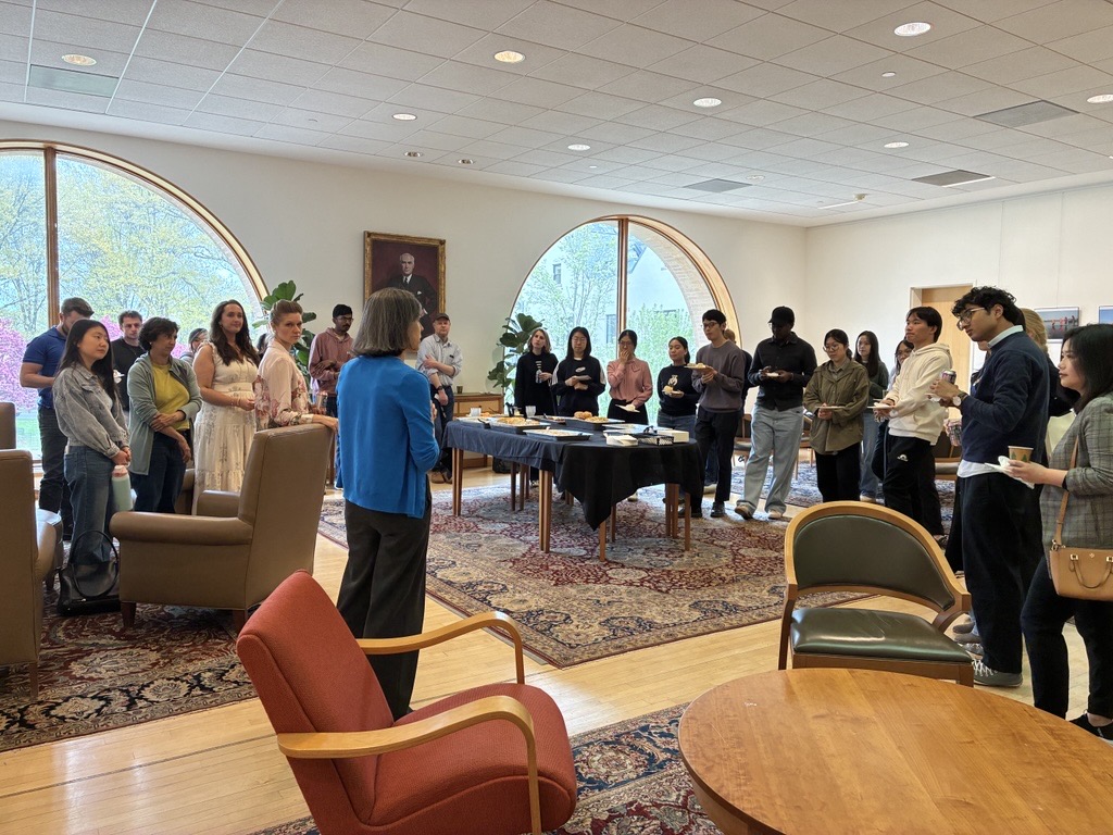 A woman speaks to a group of students