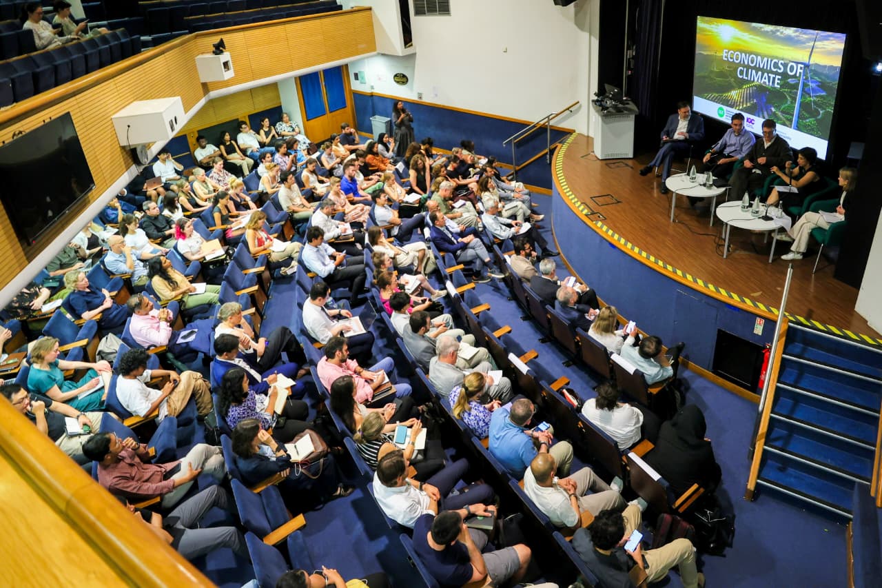 Attendees listening to speakers in an auditorium