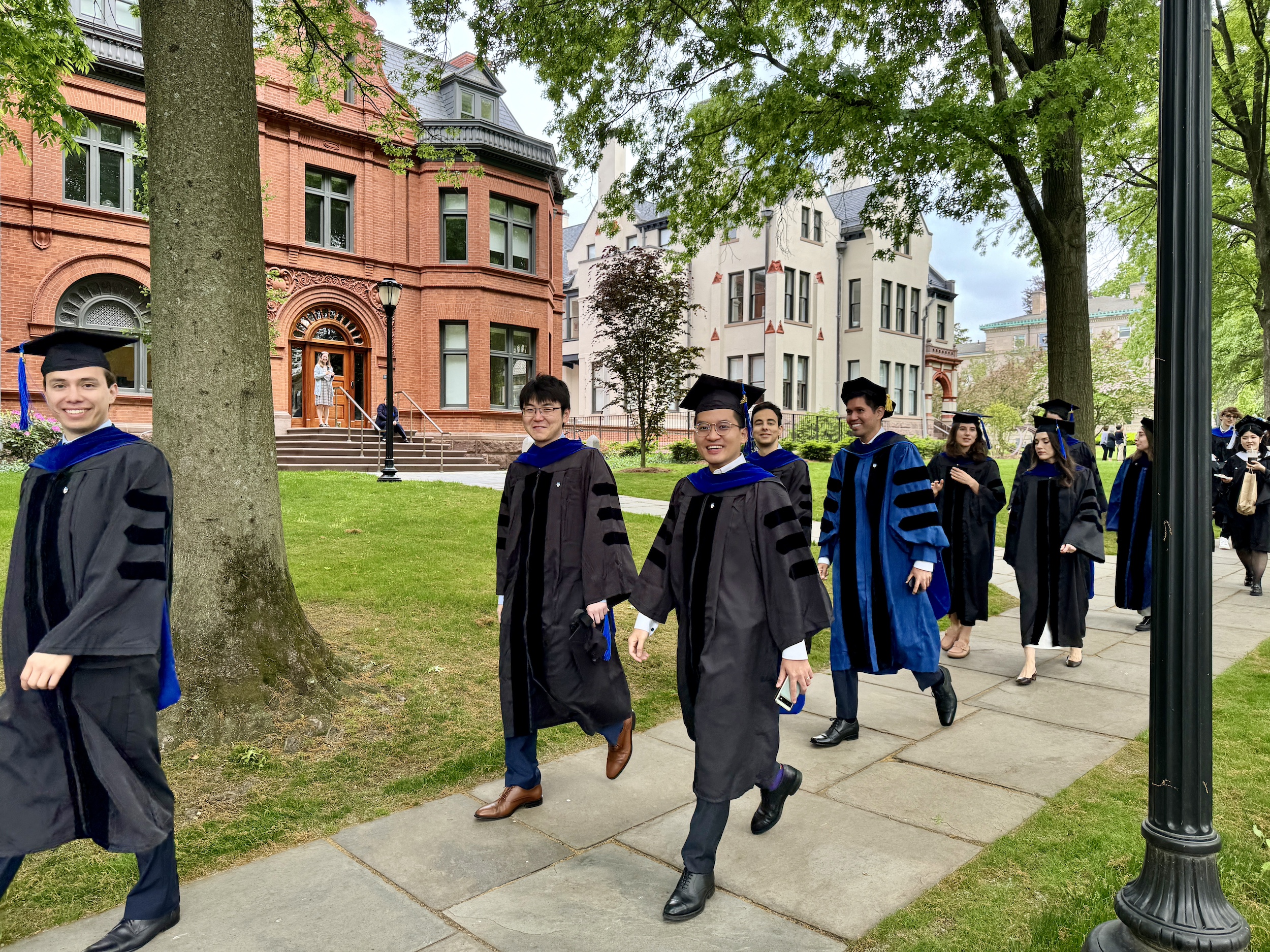 Graduates walking by the Economics Department