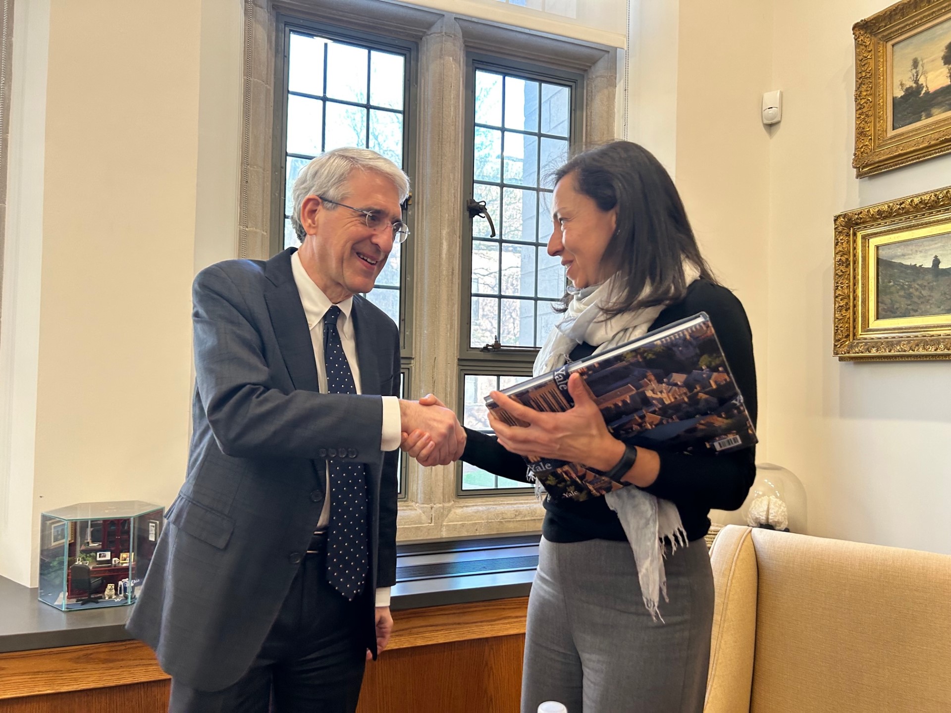 "Raquel Bernal shakes hands with Peter Salovey"