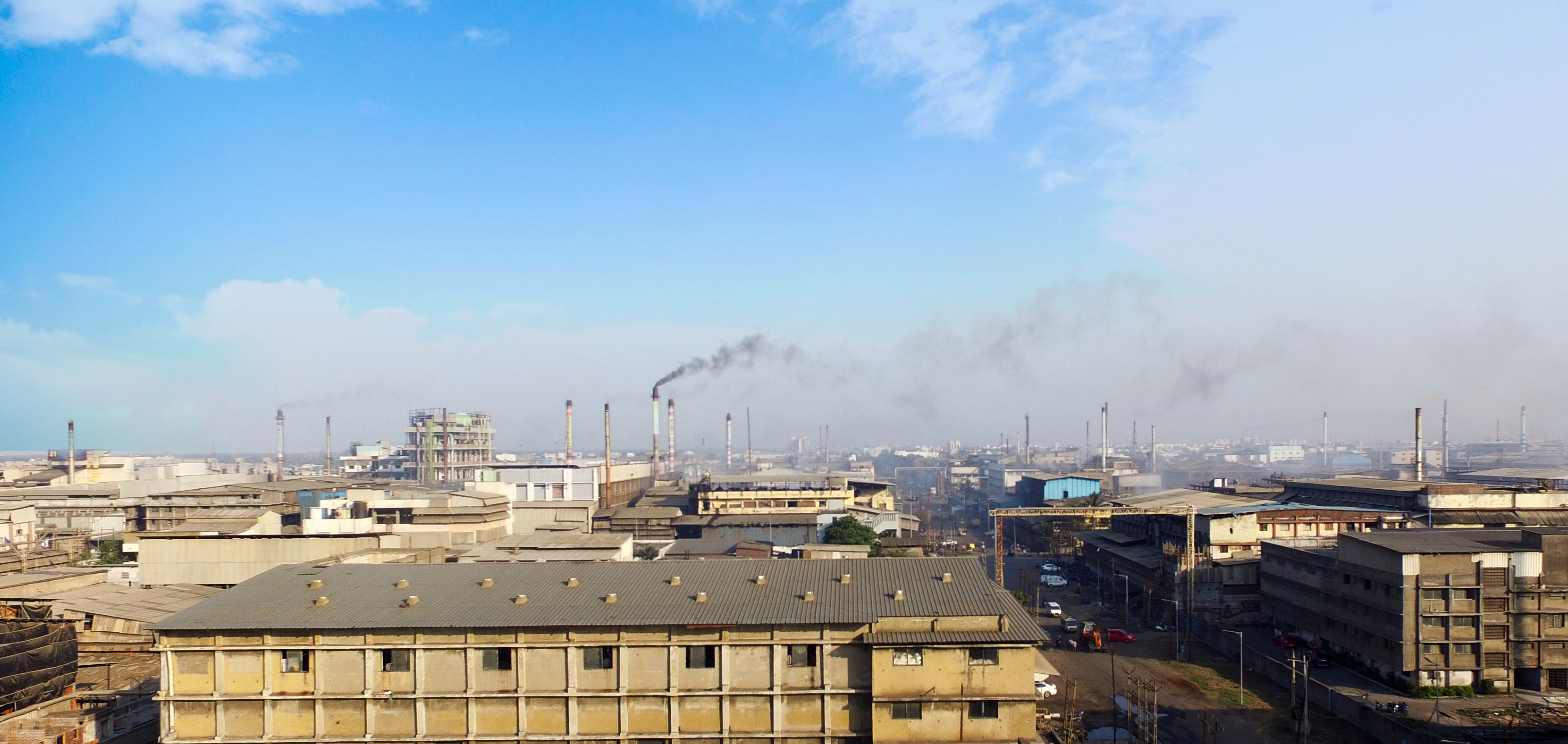 A skyline with smokestacks emitting polution