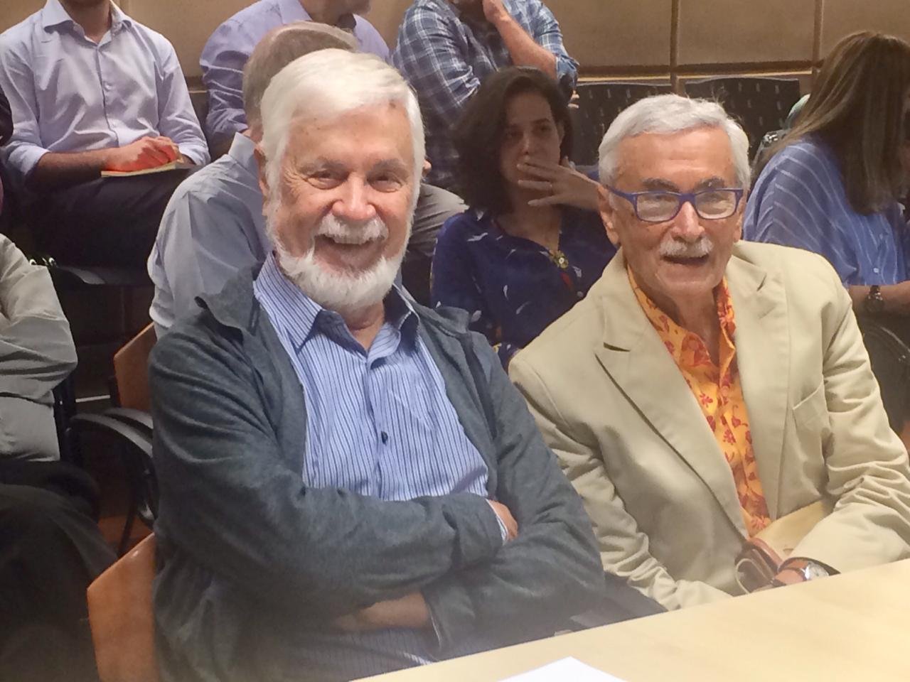 Two men smiling for the camera at a conference.