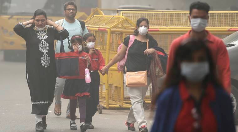 A family arrives at a protest against air pollution in New Delhi, India