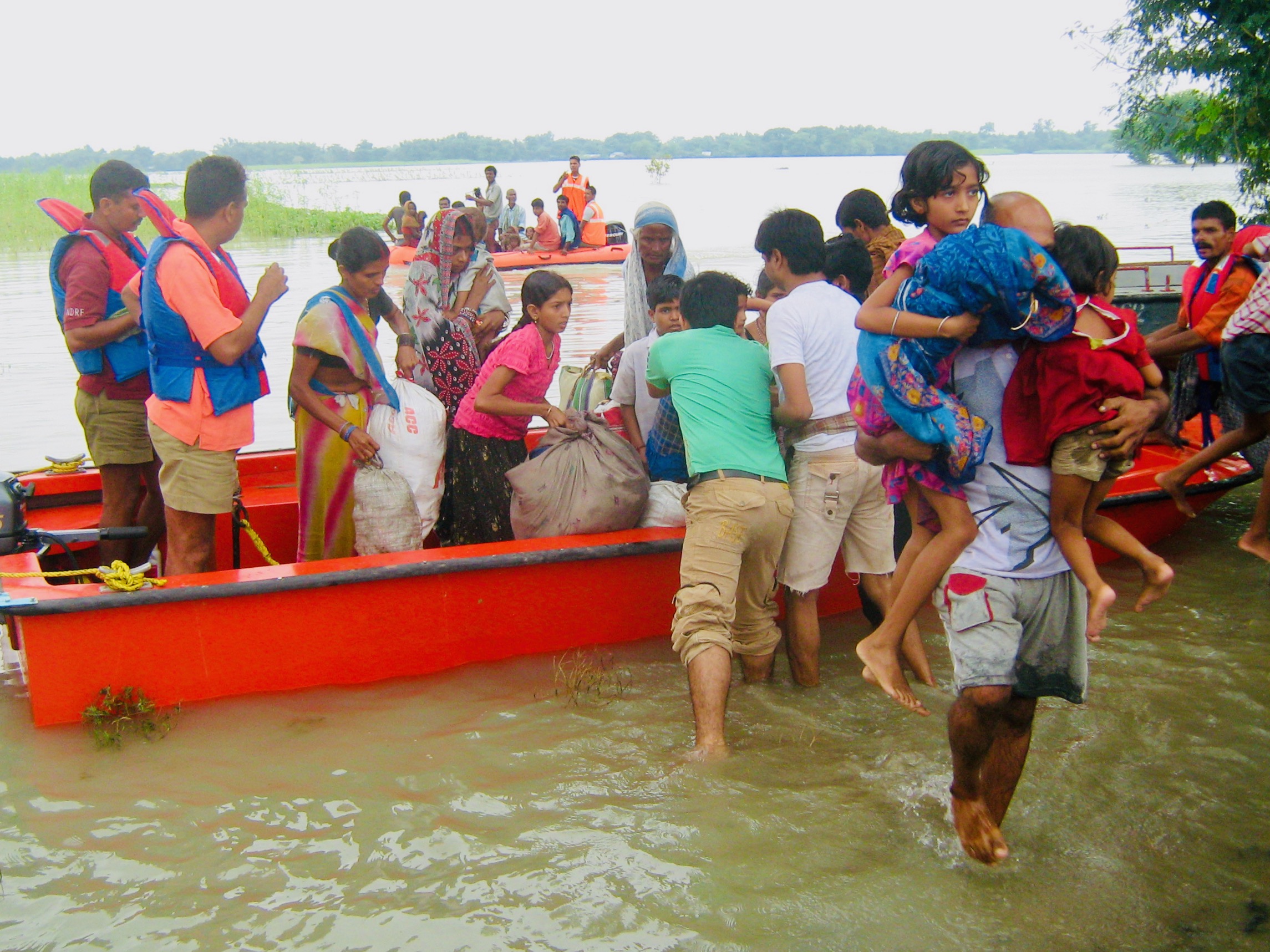 Flood victims load belongings into a boat