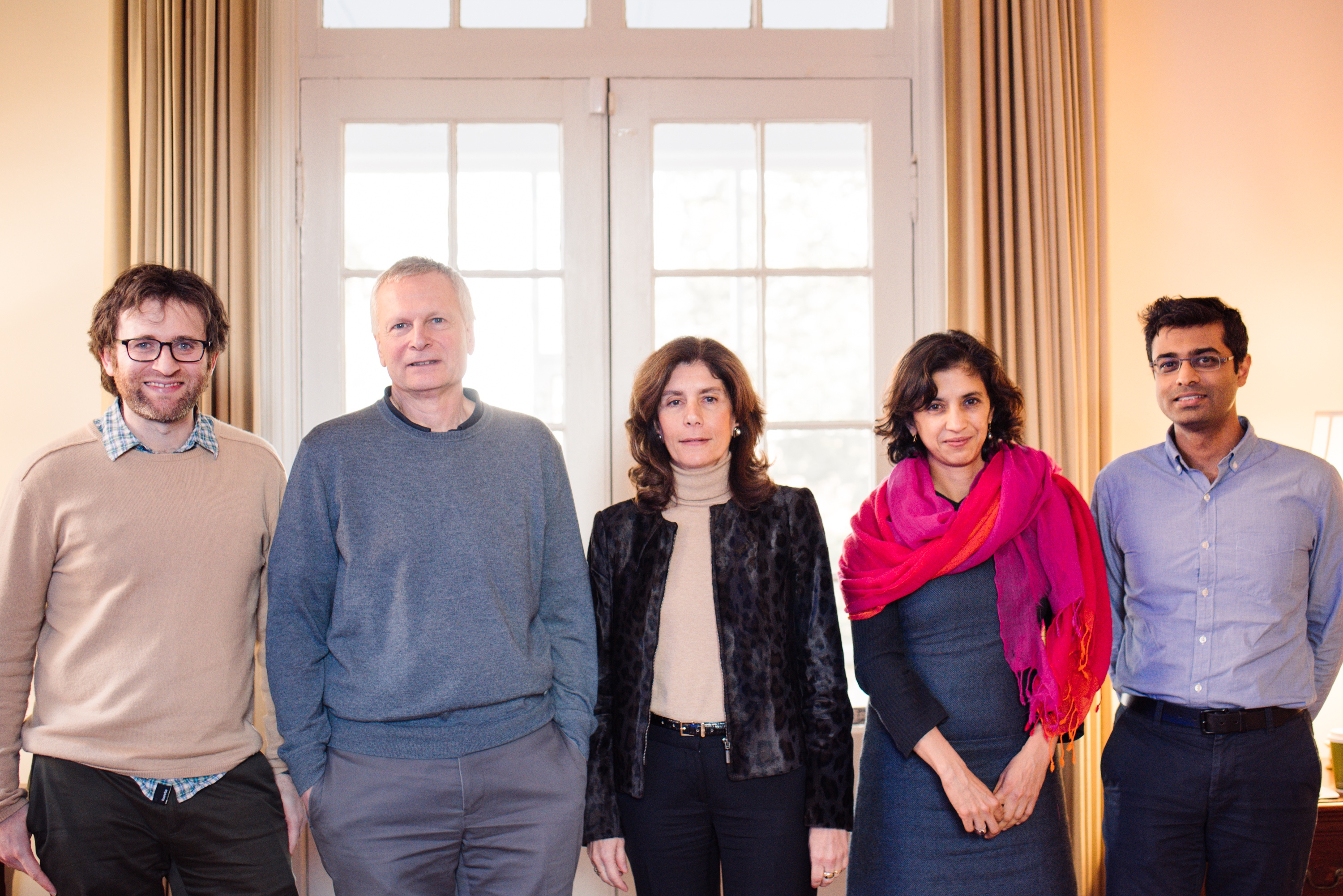 Five people standing in a row: see caption for names.