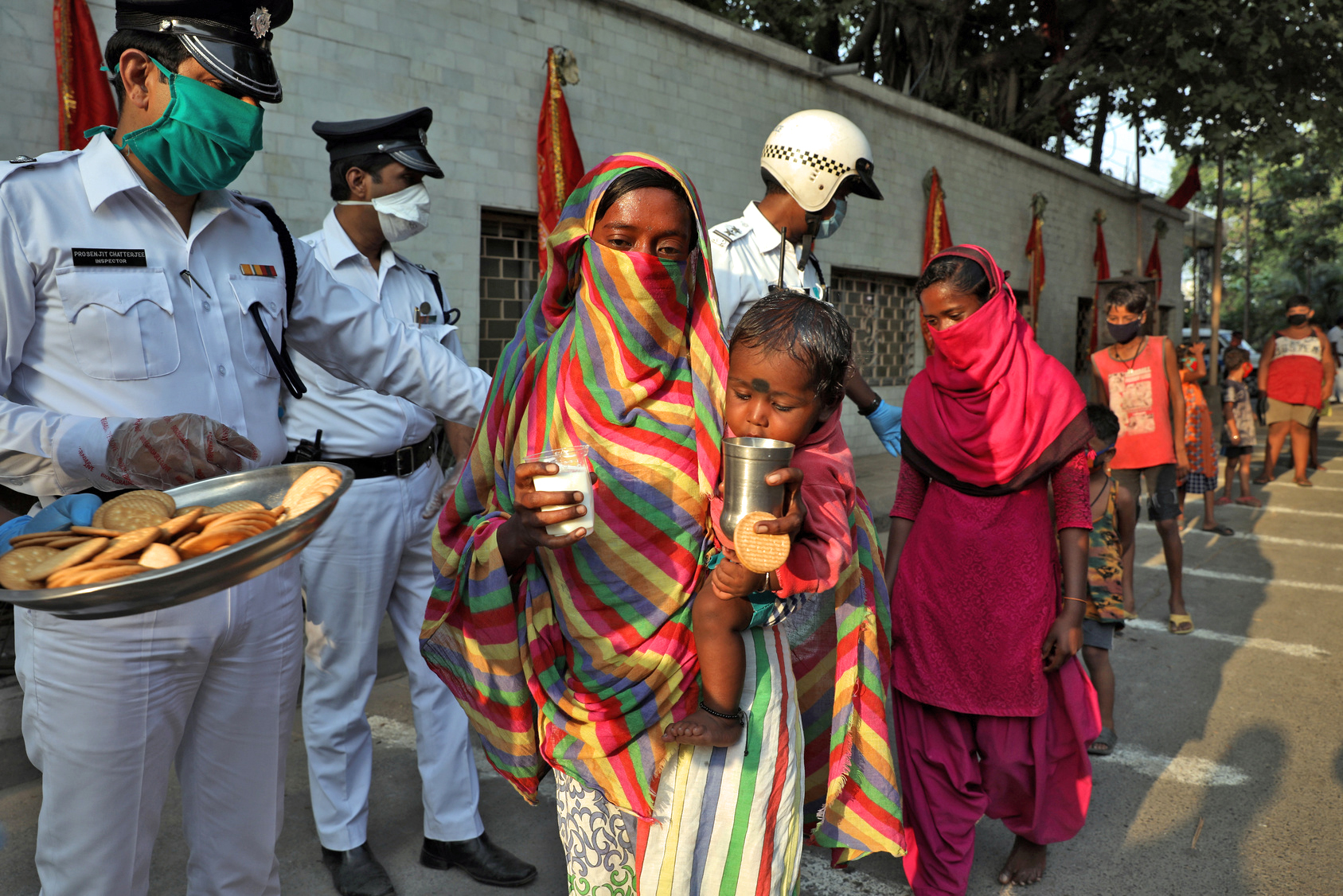 A woman stands in line for rations.