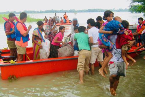 People gathering in a small boat due to flooding
