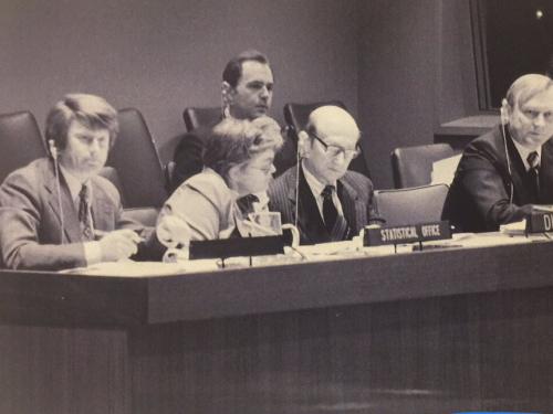 Nancy Ruggles at a UN meeting, surrounded by men