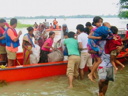 Flood victims board a boat in Bangladesh
