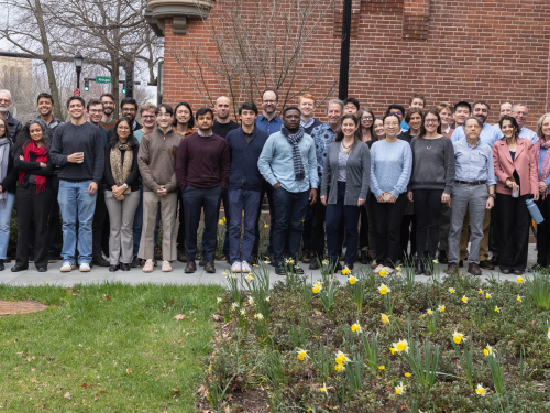 2024 Kuznets mini-conference participants pose for a photo in front of the Yale Department of Economics