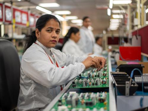 A woman working in a tech factory