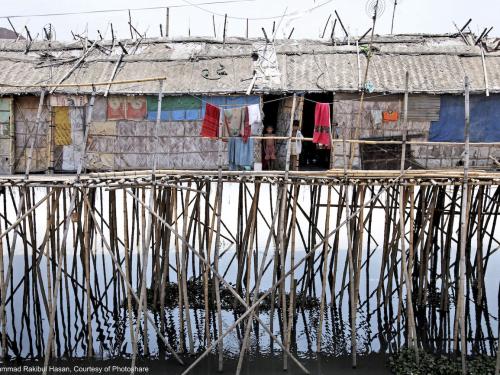 Houses on stilts in a river in Bangladesh