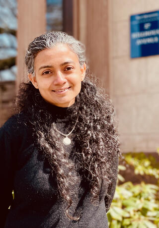 Photo of Aishwarya Lakshmi Ratan standing outside.