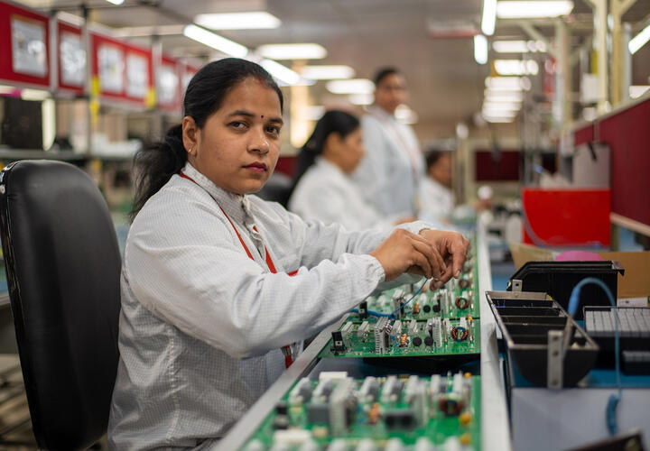 Woman sitting, working in a factory 