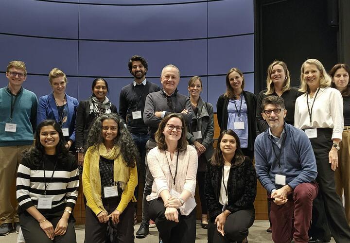 Group photo of workshop participants on stage. 