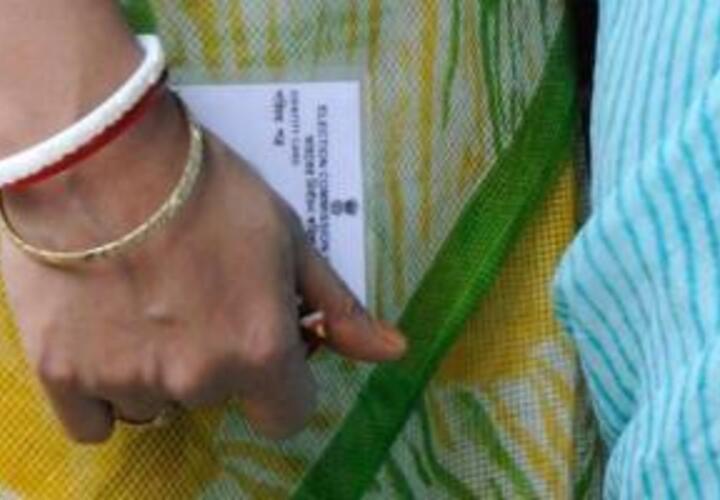 woman's hand holding election card