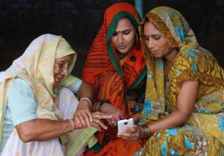 Three women using mobile