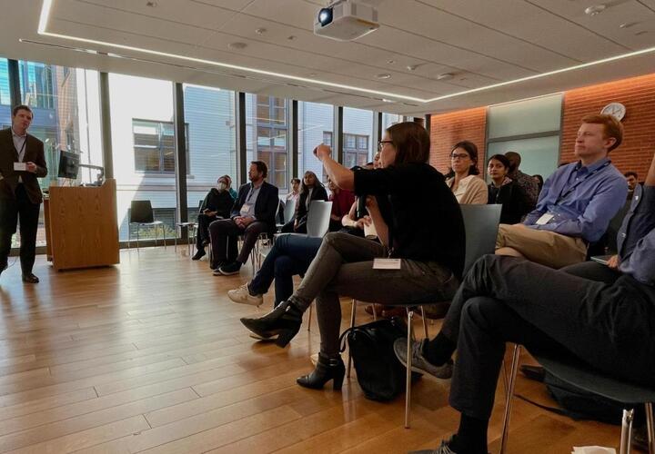 Attendees of the 2023 Firms, Trade, and Development Conference engaging with the presentation by one of the speakers