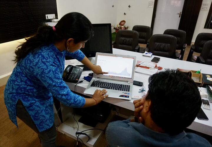 An Inclusion Economics team member showing the PayDash application to a government official in India