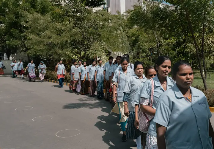 Sarika Pawar, second from right, in line with other workers for the company bus at the All Time Plastics factory in Silvassa, India. Credit: Elke Scholiers for The New York Times