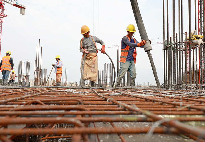 Construction workers pour concrete in Luannan County, China