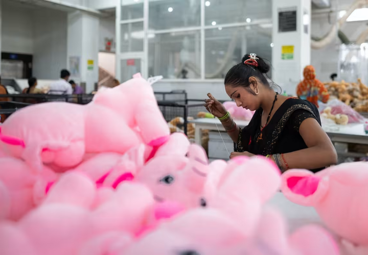 A woman operating sewing in a toy factory in India.