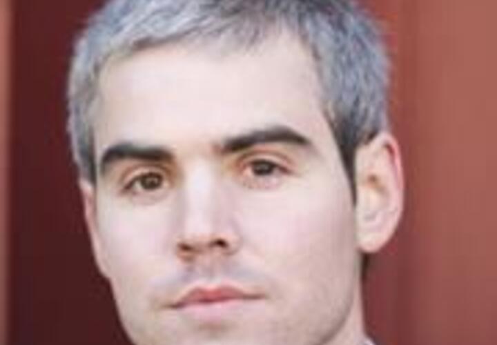 A close-up headshot of a man