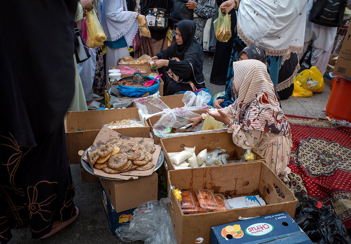 Women selling products in front of a hotel in Saudi Arabia