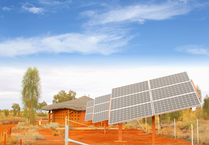 A house in a rural area with solar panels out front