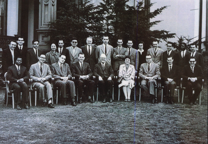 A black and white photo showing a group of students posed for a group portrait on a lawn