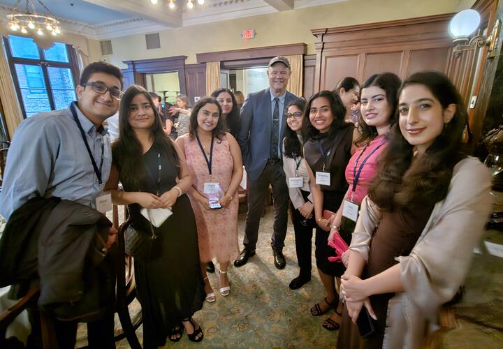 A group of students poses with their mentor