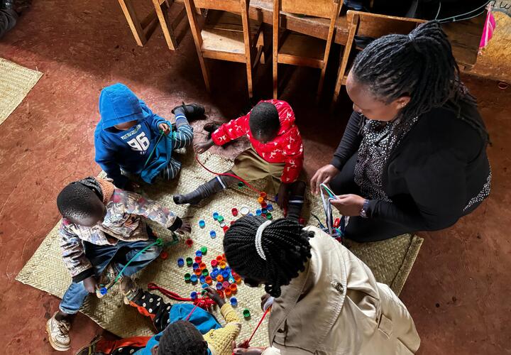 Teacher with children in a preschool in Kenya