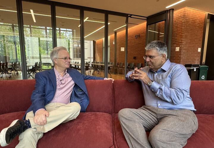 Image showing economists Costas Meghir (Yale) and Amer Hasan (World Bank) engaged in a discussion