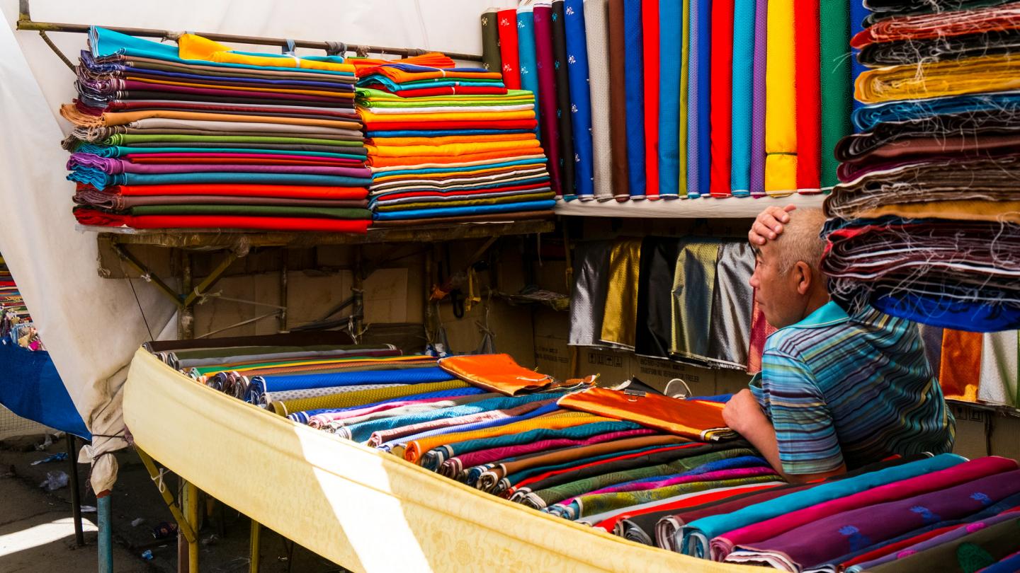 A fabric vendor in his market stall