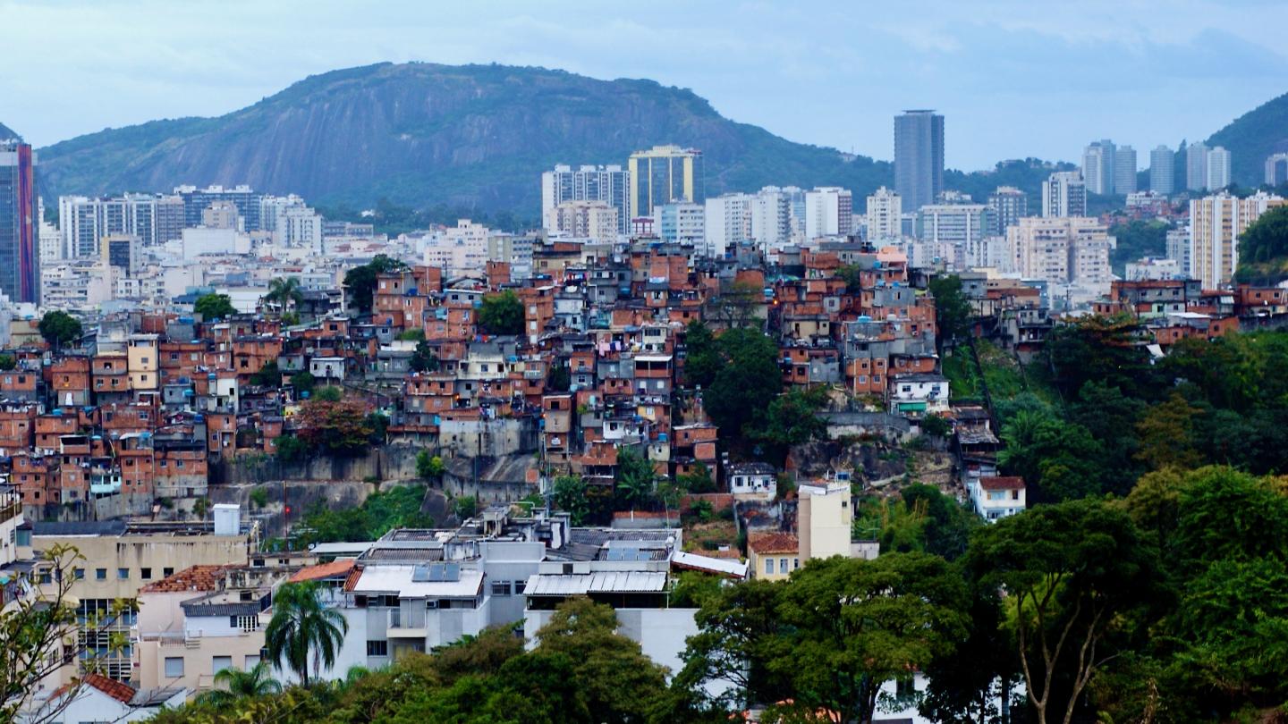 A favela in Brazil with sky scrapers in the background