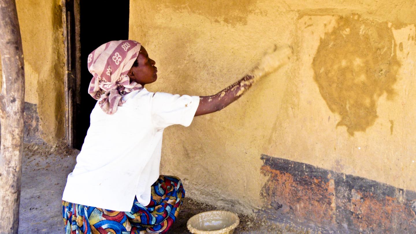 Woman painting her house in Malawi