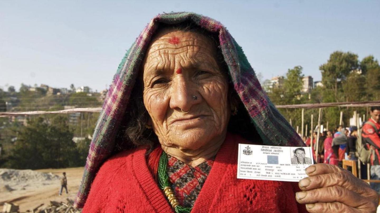 Woman holding her voter registration card