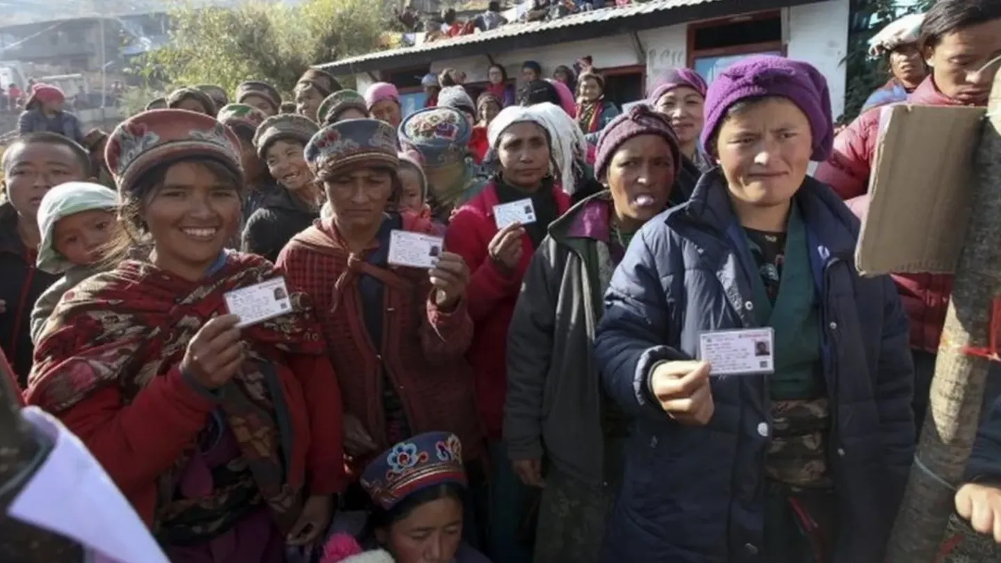 Women holding their voter registration cards in Nepal